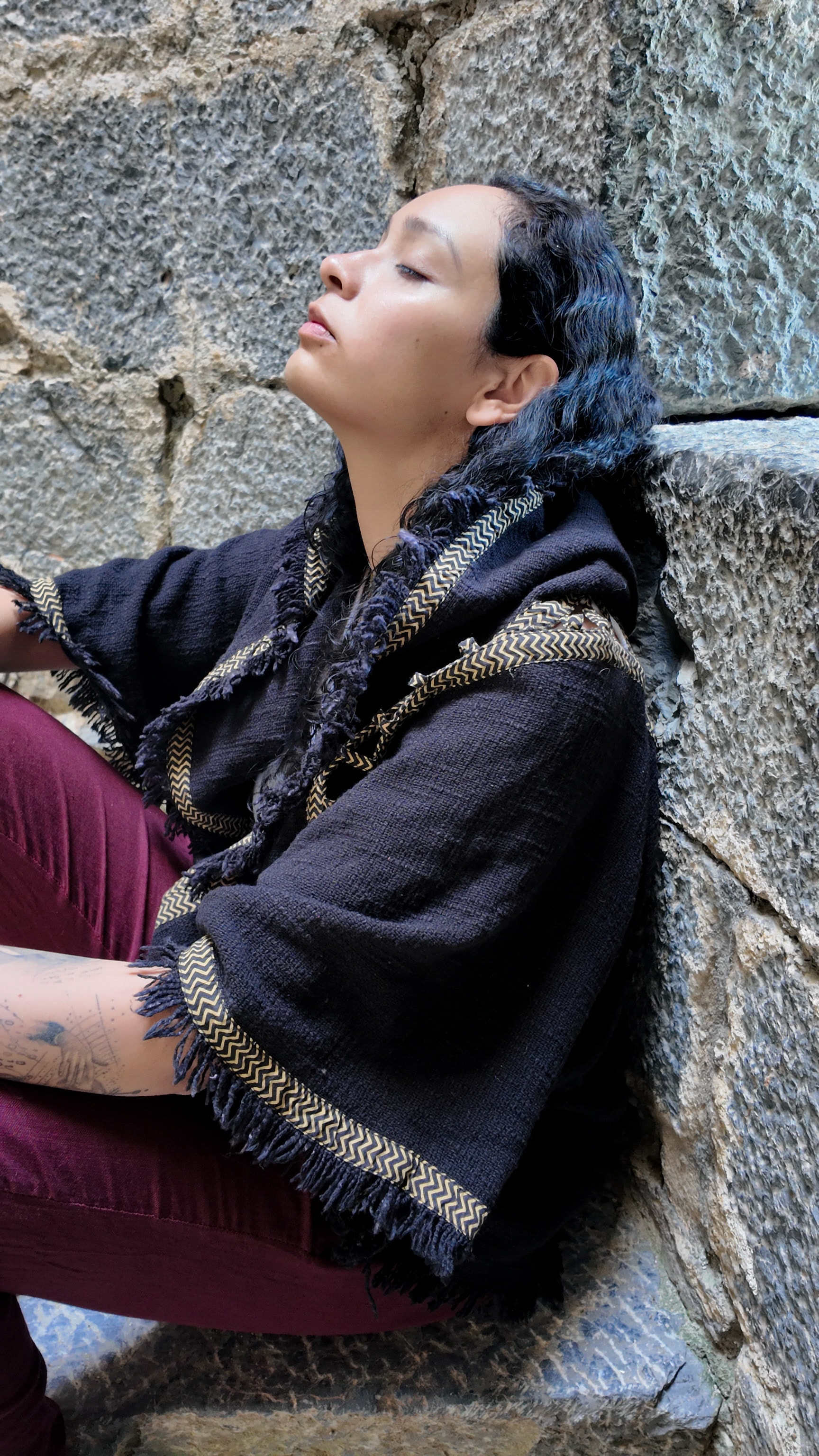 Mel Cobian resting against ancient stone